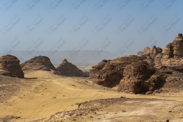 A snapshot of various rock formations from the city of AlUla in the desert, layers of rocks, plants in the ancient oasis of AlUla