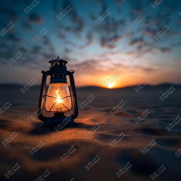 An old lit lantern on the sand in the desert with a sunset in the background. The horizon shows sand dunes under a sky filled with scattered clouds, creating a peaceful and warm scene.