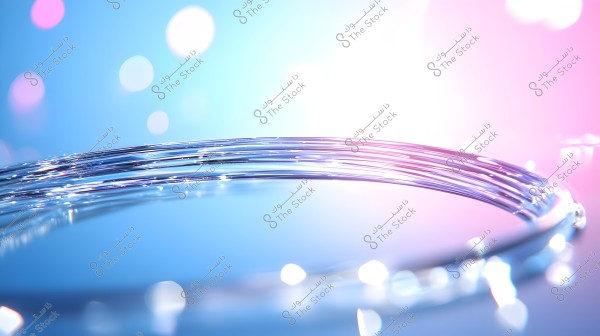 Image of intertwined transparent optical fibers reflecting blended colors of blue and pink. The background is filled with soft lighting and bokeh effect, giving the image an abstract and modern feel.
