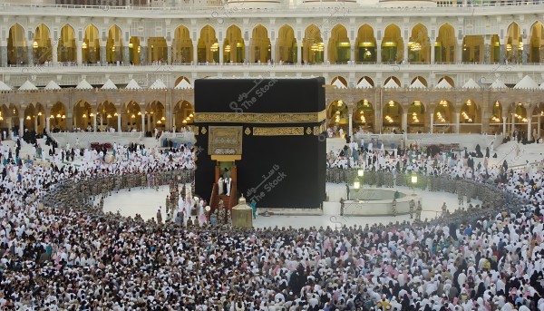 Image of the Grand Mosque in Mecca showing the Kaaba surrounded by a large crowd of pilgrims performing Tawaf.