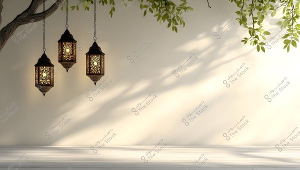 Three traditional Arabic lanterns hanging from a tree, with intricate designs illuminating towards the left. Shadows of leaves appear on a white wall background, adding to the serene ambiance of the courtyard.