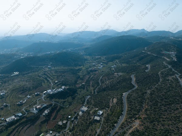 A shot of a series of mountains and green areas in the city of Abha in southern Saudi Arabia, houses on mountain heights, nature in Saudi Arabia