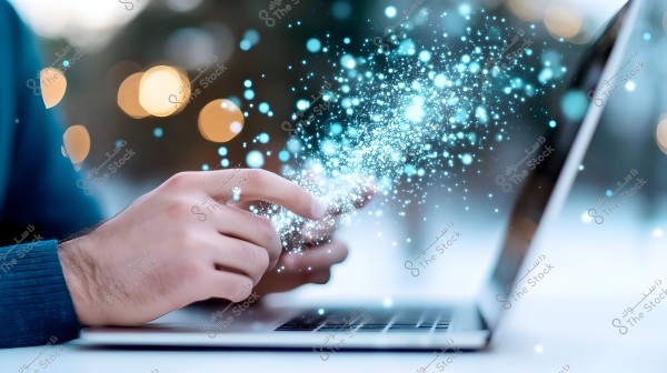 A hand appears to be touching a laptop screen, with blue sparkling lights in circular shapes glowing from the screen. The background is blurred with some faint yellow lights.