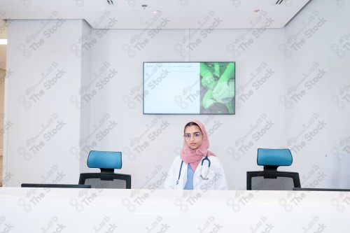 A Saudi doctor wearing a medical coat, working in the health sector, providing health services, medicine and health care