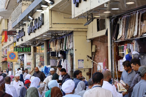 Mecca, Saudi Arabia - March 12 2025: people buying products from market shop in Mecca close to Masjid al-Haram, pilgrims umrah shopping in Makkah