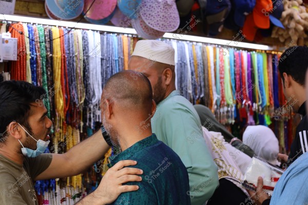 Mecca, Saudi Arabia - March 12 2025: people buying products from market shop in Mecca close to Masjid al-Haram, pilgrims umrah shopping in Makkah