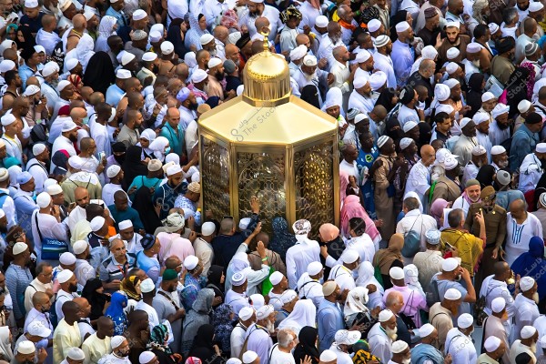 A group of Muslim pilgrims surrounding the Station of Ibrahim in the Grand Mosque in Mecca.