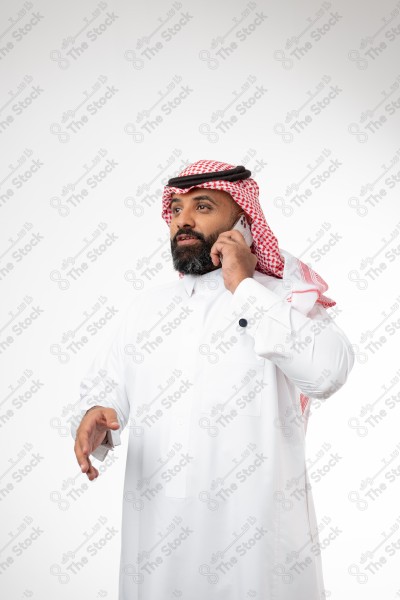 Portrait of a Saudi man holding a phone and making a phone call with different expressions