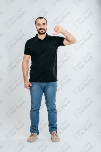 Portrait of a Saudi man on a white background making hand gestures while smiling, souvenir photos, documenting a happy moment