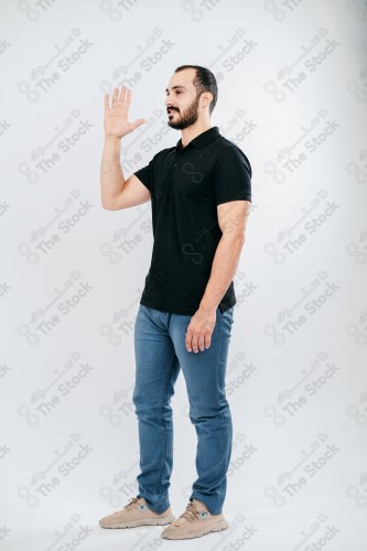 Portrait of a Saudi man on a white background making hand gestures while smiling, souvenir photos, documenting a happy moment