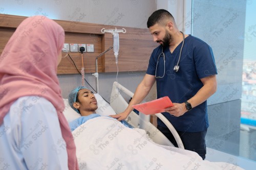 Saudi female doctor and paramedic in medical uniform and examining and applying nutritional solution, medicine and health care