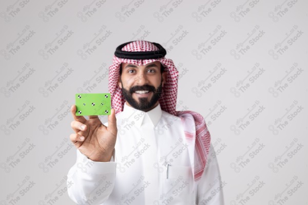 بورتريه رجل سعودي يحمل بطاقة خضراء على خلفية بيضاء