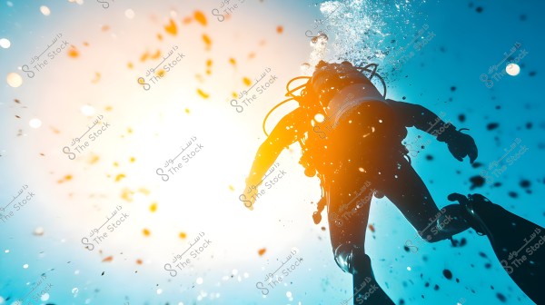 A diver wearing a diving suit, mask, and oxygen tank is swimming underwater. The bubbles and rays of light penetrating the water create a colorful and bright atmosphere in the image.