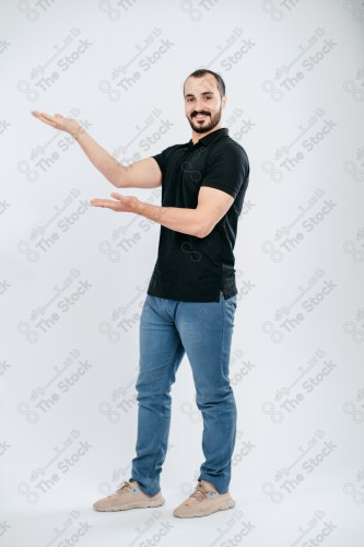 Portrait of a Saudi man on a white background making hand gestures while smiling, souvenir photos, documenting a happy moment