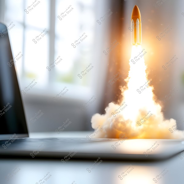 A small rocket launching from a desktop surface, next to an open laptop. Bright light and smoke are emanating from the base of the rocket. In the background, there is a large window illuminated by daylight.