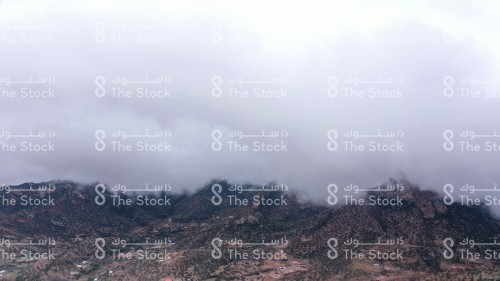 Clouds rising to the top of the rocky Sarawat mountain range in the Kingdom of Saudi Arabia