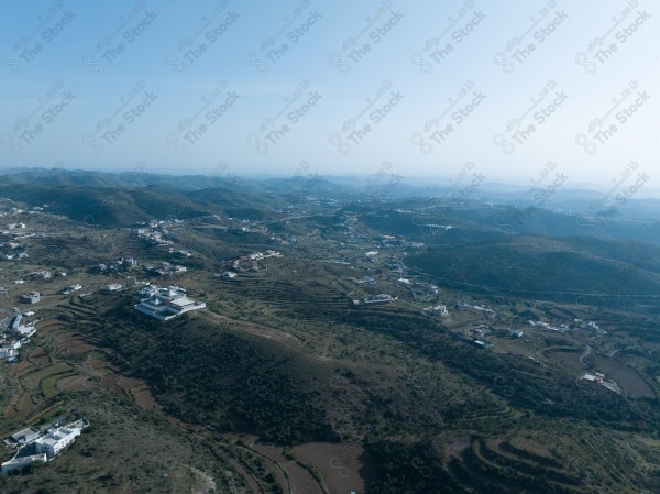 A shot of a series of mountains and green areas in the city of Abha in southern Saudi Arabia, houses on mountain heights, nature in Saudi Arabia