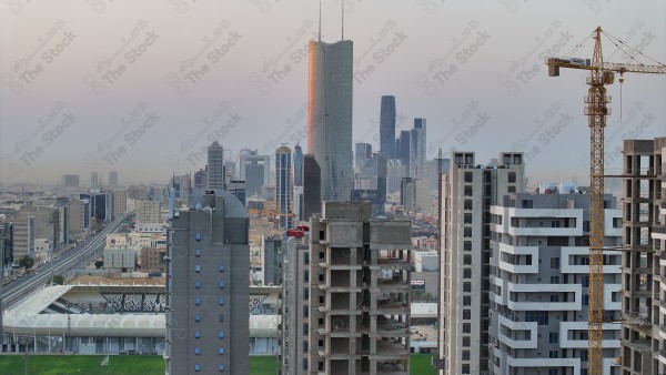 A snapshot showing the buildings and landmarks of the city of Riyadh, in front of it is a group of residential houses and the sky appears clear, buildings and landmarks.