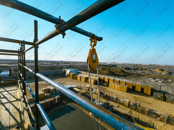 A construction site with a large building in the background. multi-storey building. A construction site with scaffolding and a large building in the background.