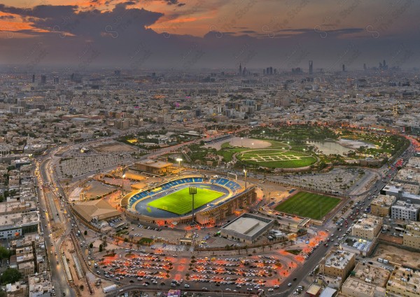 An overhead shot showing Al Malaz Stadium and landmarks of the city of Riyadh at sunset, buildings and landmarks, sports.