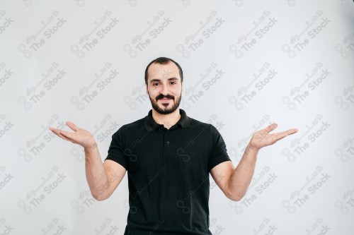 Portrait of a Saudi man on a white background making hand gestures while smiling, souvenir photos, documenting a happy moment