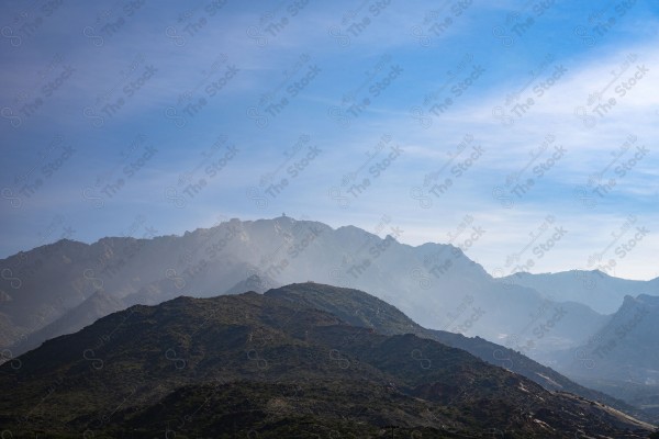 لقطة لسلسلة من الجبال الصخرية والطرق الوعرة الممتدة بالجبل في مدينة الطائف السماء ملبدة بالغيوم غرب السعودية ، سلسلة الجبال الصخرية ، الطبيعة بالسعودية.