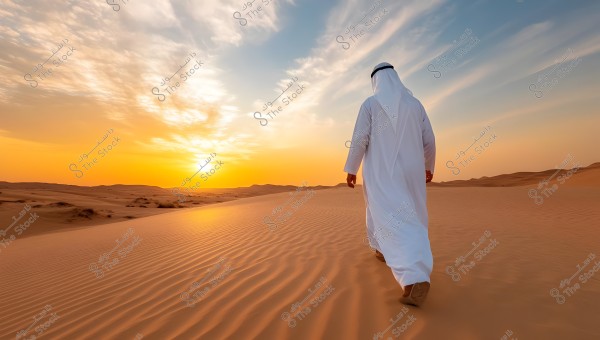 A man wearing a white robe walks on sandy dunes in a desert under a vast sky, with the sunset beautifully visible on the horizon, casting warm colors on the sand.