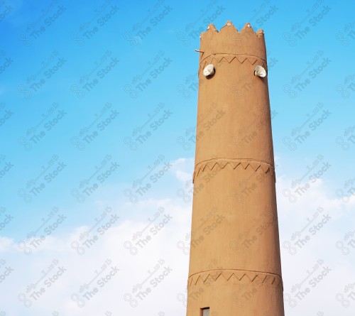 A heritage tower built of mud, and the sky appears almost clear during the day