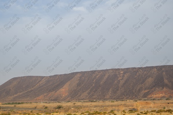 A snapshot of a high plateau in Al-Jamoum Governorate in the Makkah Al-Mukarramah region during the day, showing a clear sky, nature in Saudi Arabia.