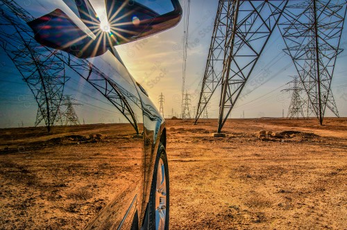 A shot of the car's reflection in the middle of the desert, showing the sky overcast with clouds