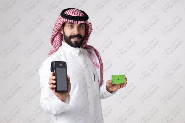 Portrait of a Saudi man holding an automatic payment device and a card and making different expressions