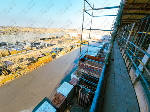 A construction site with a large building in the background. multi-storey building. A construction site with scaffolding and a large building in the background.