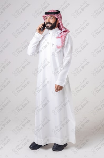 Portrait of a Saudi man holding a phone and making a phone call with different expressions