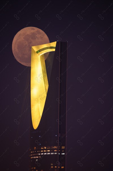 moon behind the kingdom tower