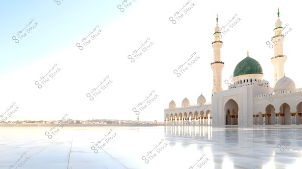Image of a large mosque with stunning Islamic architecture. The mosque features a prominent green dome surrounded by tall white minarets. The front courtyard is expansive, adorned with shiny tiles that reflect light. In the background, there\'s a view of the city under a clear blue sky.