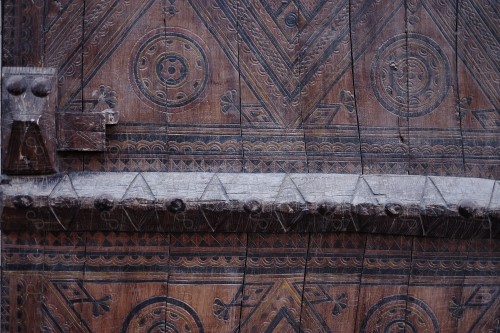 Wooden Antique door built into mud wall - Old traditional wooden door in Saudi Arabia