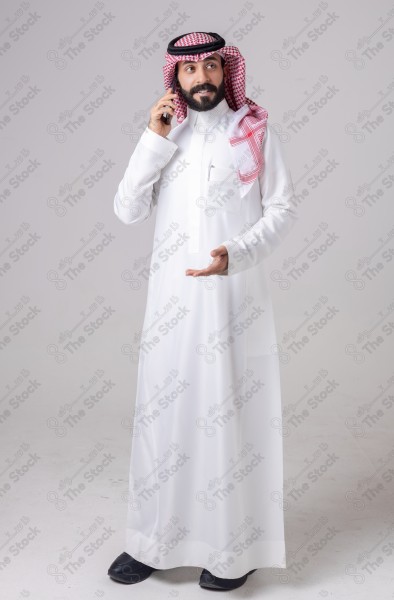 Portrait of a Saudi man holding a phone and making a phone call with different expressions