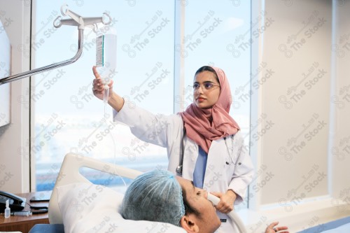 A Saudi female doctor wears a medical uniform and is examining and applying a nutrient solution, medicine and health care