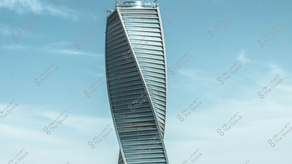 Image of a skyscraper with a modern spiral design consisting of multiple floors with a glass facade reflecting the blue sky. The design is characterized by its sleek lines and metal structure twisting from the base to the top.