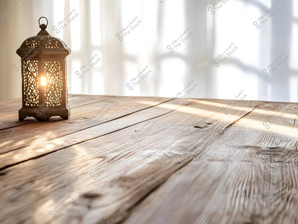 A decorative metal lantern is warmly illuminated, sitting on an old wooden table. Sunlight streams through the window, casting soft shadows on the white curtains and the wood, creating a warm and serene atmosphere.