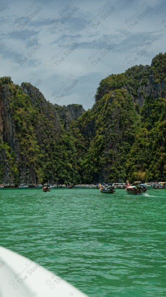 Aesthetic shot from inside a boat on James Bond Island in the Thailand region and the sky appears cloudy during the day, nature in Thailand, island, mountains