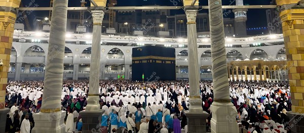 Muslims performing Tawaf around the Kaaba in the Grand Mosque in Mecca, under night lighting.