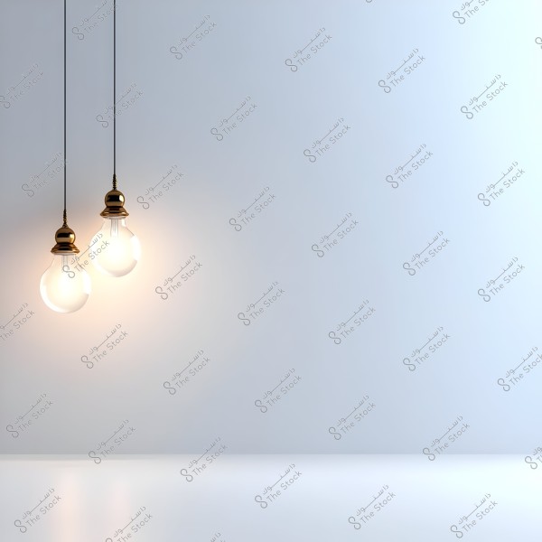 Two hanging light bulbs emitting warm white light in an empty room with white walls and floors. The bulbs have metallic bases, and their glow creates a warm contrast with the minimalistic and serene surroundings.