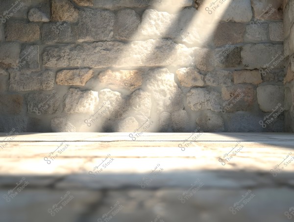 A stone wall made up of uneven stones with sunlight casting onto the wall, creating soft shadows. The foreground is slightly blurred, focusing the clarity on the wall.