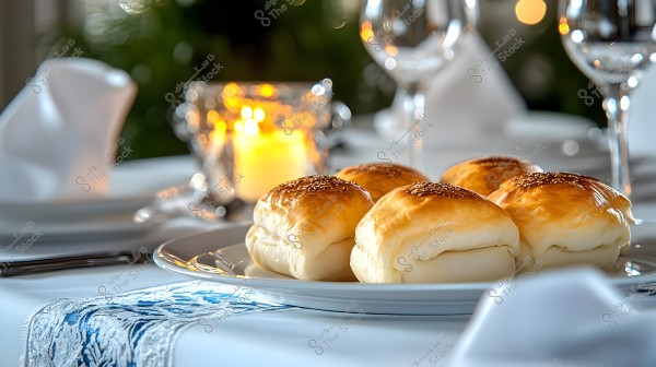 A photo of a plate containing several pieces of cheese-stuffed bread rolls topped with sesame seeds, placed on a formally set dining table with a white decorated tablecloth, candlelight in the background, and some glassware.