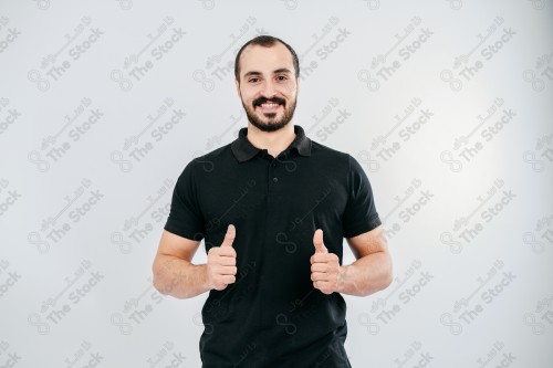 Portrait of a Saudi man on a white background making hand gestures while smiling, souvenir photos, documenting a happy moment