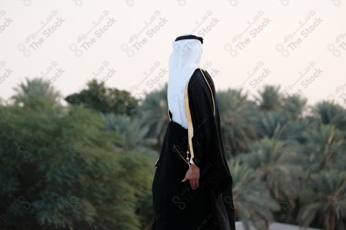 A young Saudi man wears the traditional Saudi dress in a traditional house