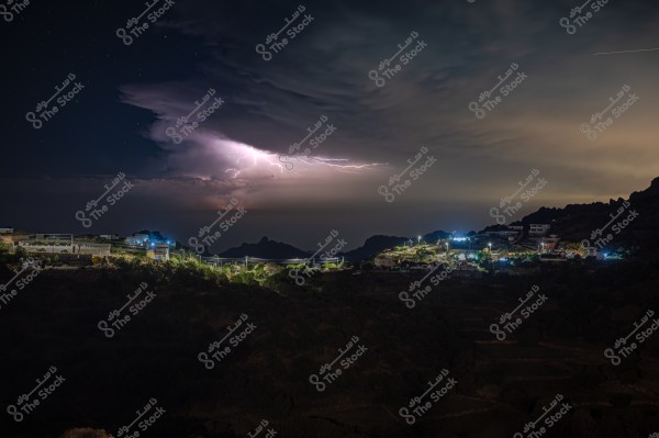 A stunning night landscape featuring lightning illuminating the sky above a mountainous area. On the left side of the image, scattered houses are lit with blue and green lights, highlighting the terraced layers of the mountains in the background. The sky is filled with clouds, while the horizon is softly illuminated with gradients of light.