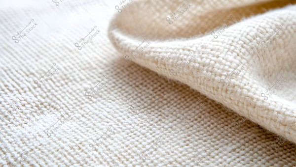 Close-up image of white fabric texture with clear details of woven stitches. The fabric is slightly wrinkled in one corner, adding depth to the texture.