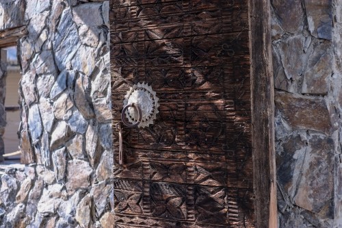 Wooden Antique door built into mud wall - Old traditional wooden door in Saudi Arabia